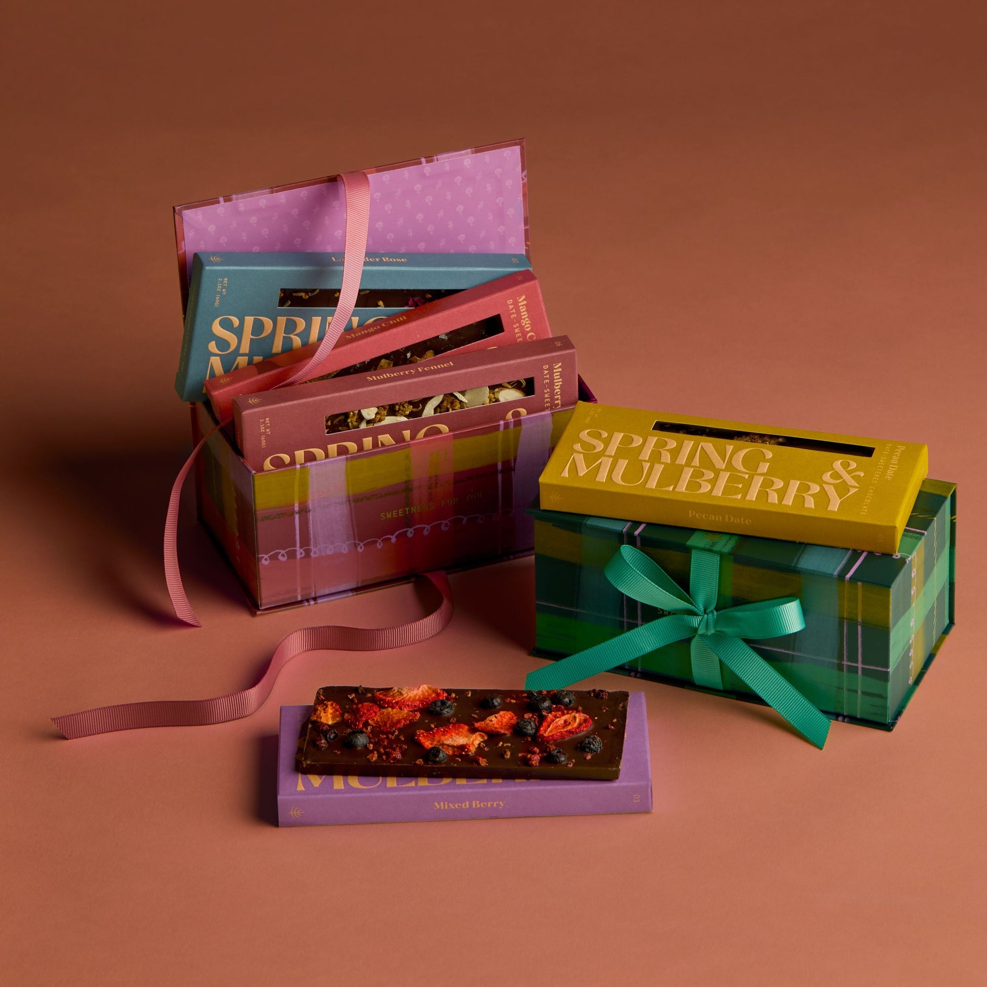 Colorful gift boxes with ribbons on a brown background