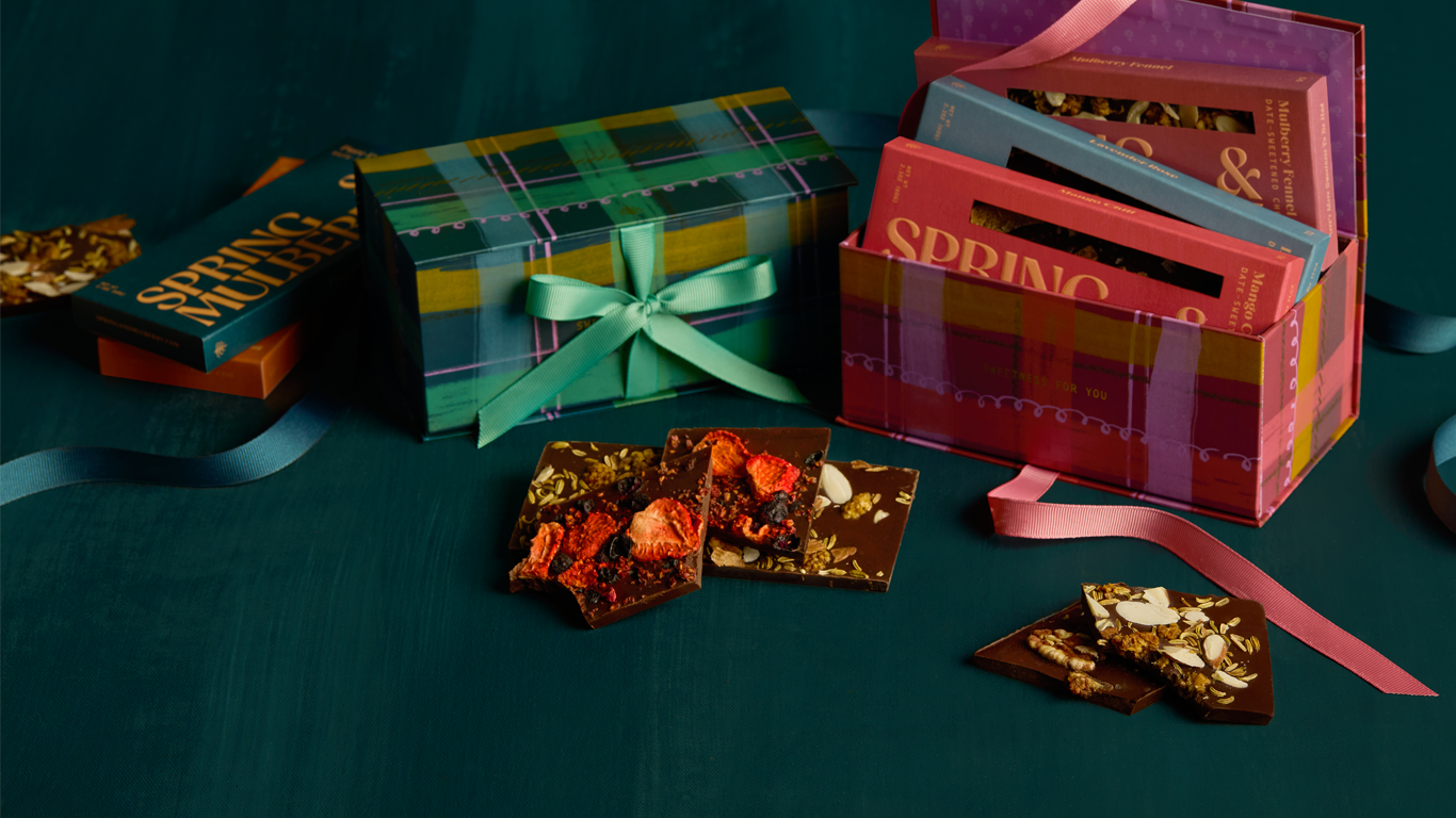 Assorted chocolates and gift boxes on a dark surface