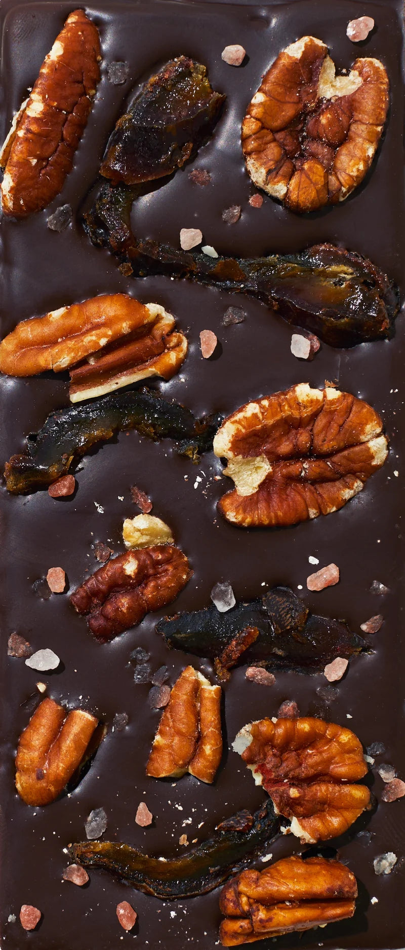 Unwrapped Spring & Mulberry Pecan Date dark chocolate bar topped with pecans and dates