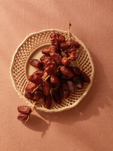 Dried Dates on an intricately weaved plate