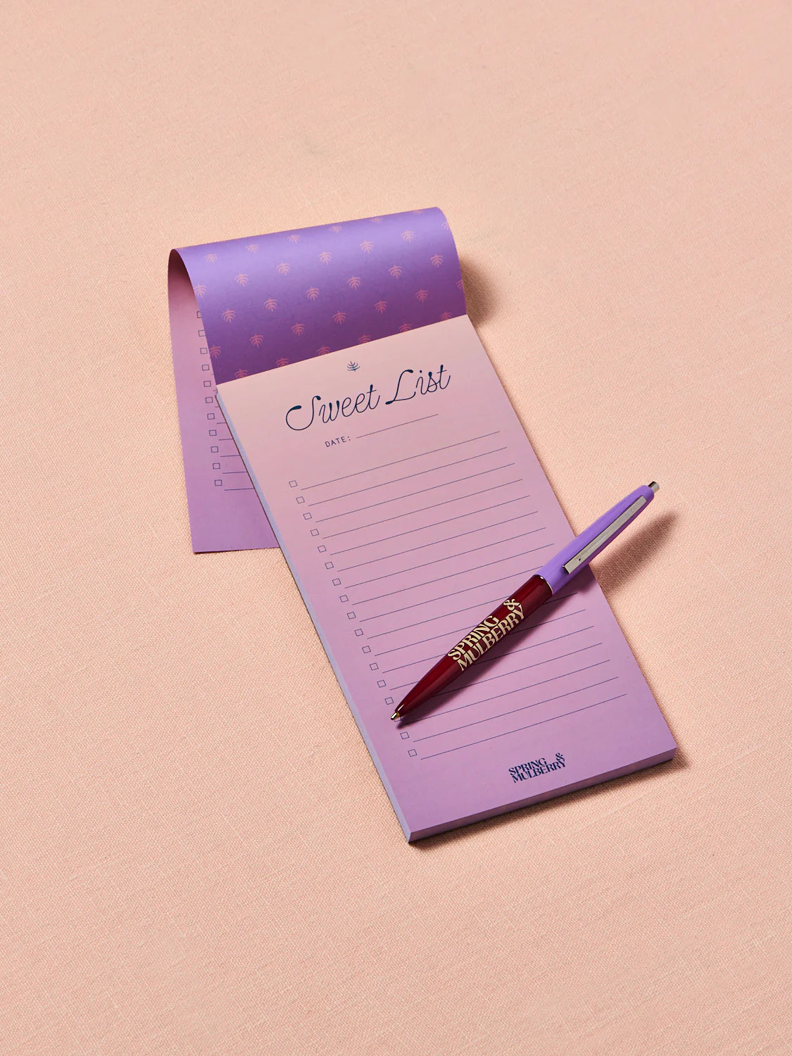 Lavender ombre notepad opened showing an embossed dark purple background with a mulberry branch opened up to a'Sweet List' with a spring and mulberry pen on a pink background