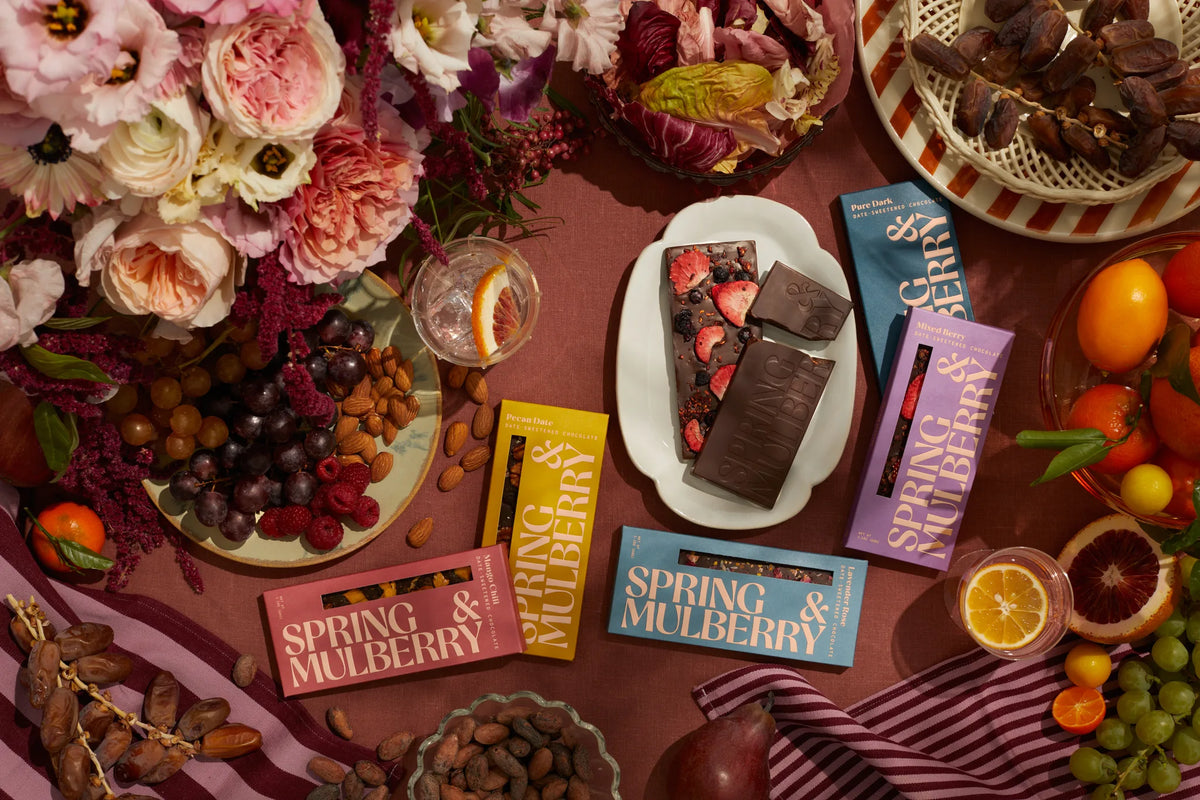 Spring & Mulberry chocolate and flowers arranged on a table