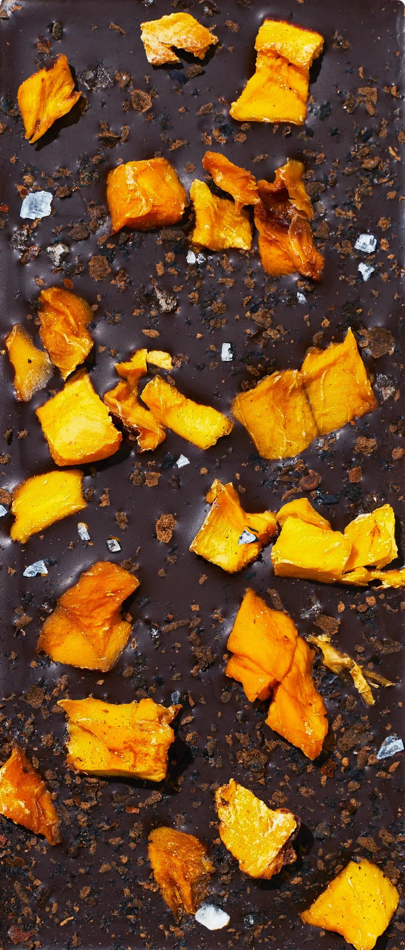Unwrapped Spring & Mulberry Mango Chili dark chocolate bar topped with mango pieces and chili flakes