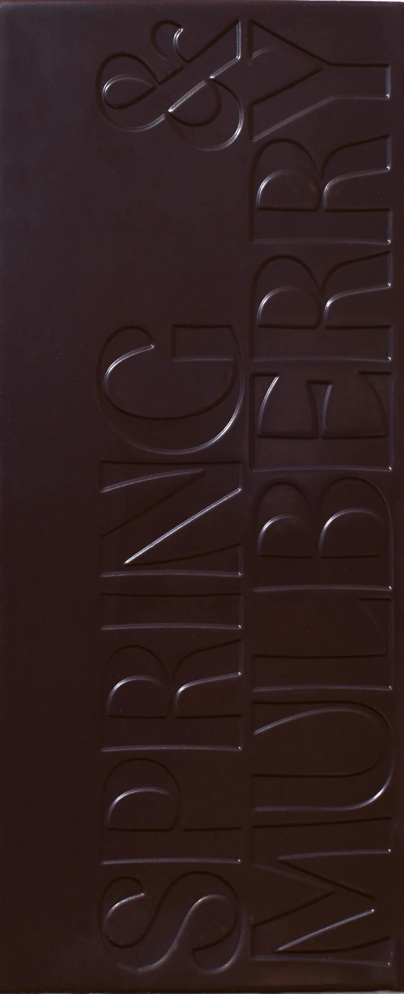 Unwrapped Spring & Mulberry Mint Leaf chocolate bar embossed with the Spring & Mulberry logo